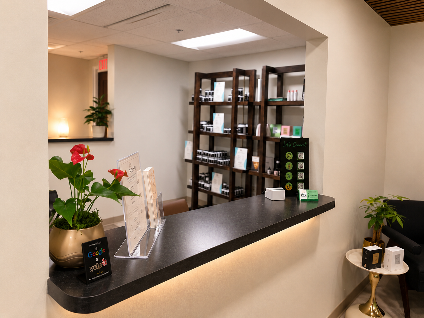 ARC Wellness front desk with product shelving, review sign, and social QR display