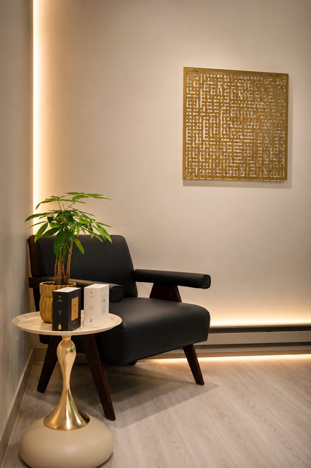 ARC Wellness waiting nook with black armchair and gold geometric wall art